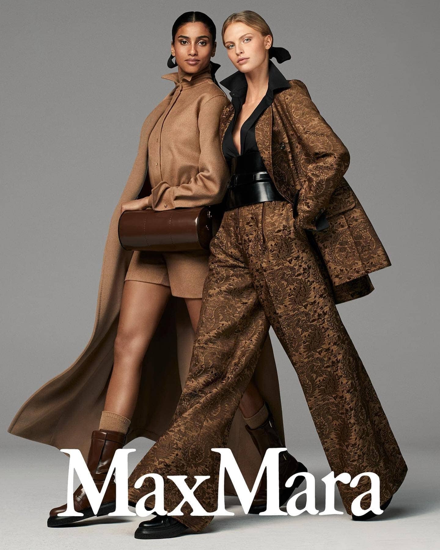 Fashion models pose indoors wearing coordinated tan and brown outfits, styled with boots and belts, standing against a neutral backdrop.