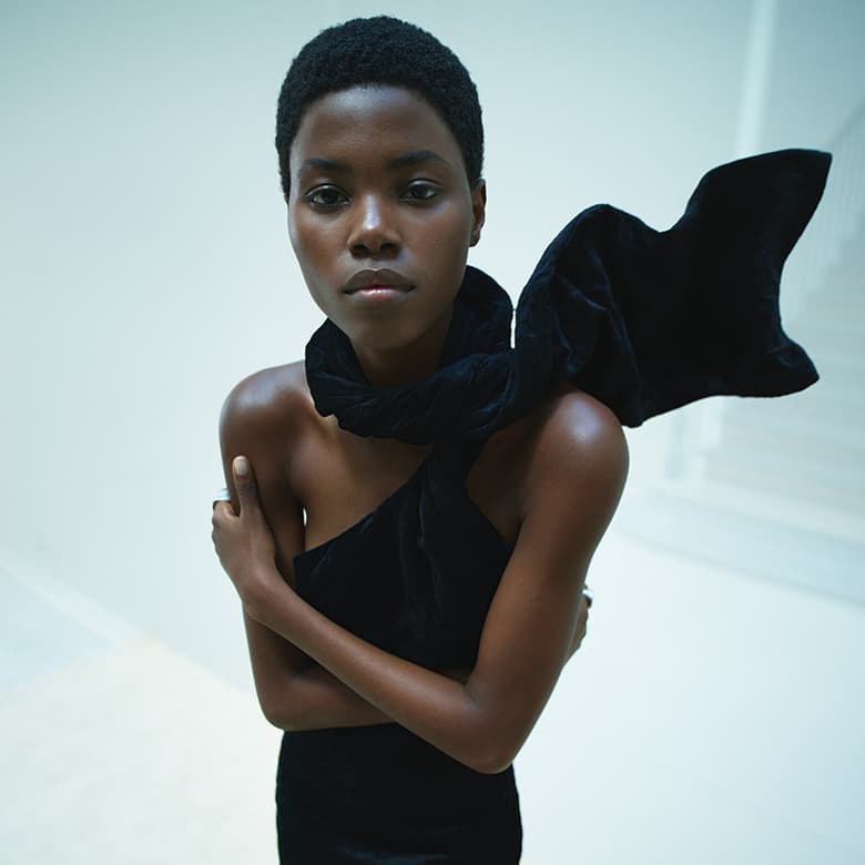Model Victoria Fawole wearing a black draped velvet scarf and asymmetrical top for the Sportmax Fall 2023 campaign.
