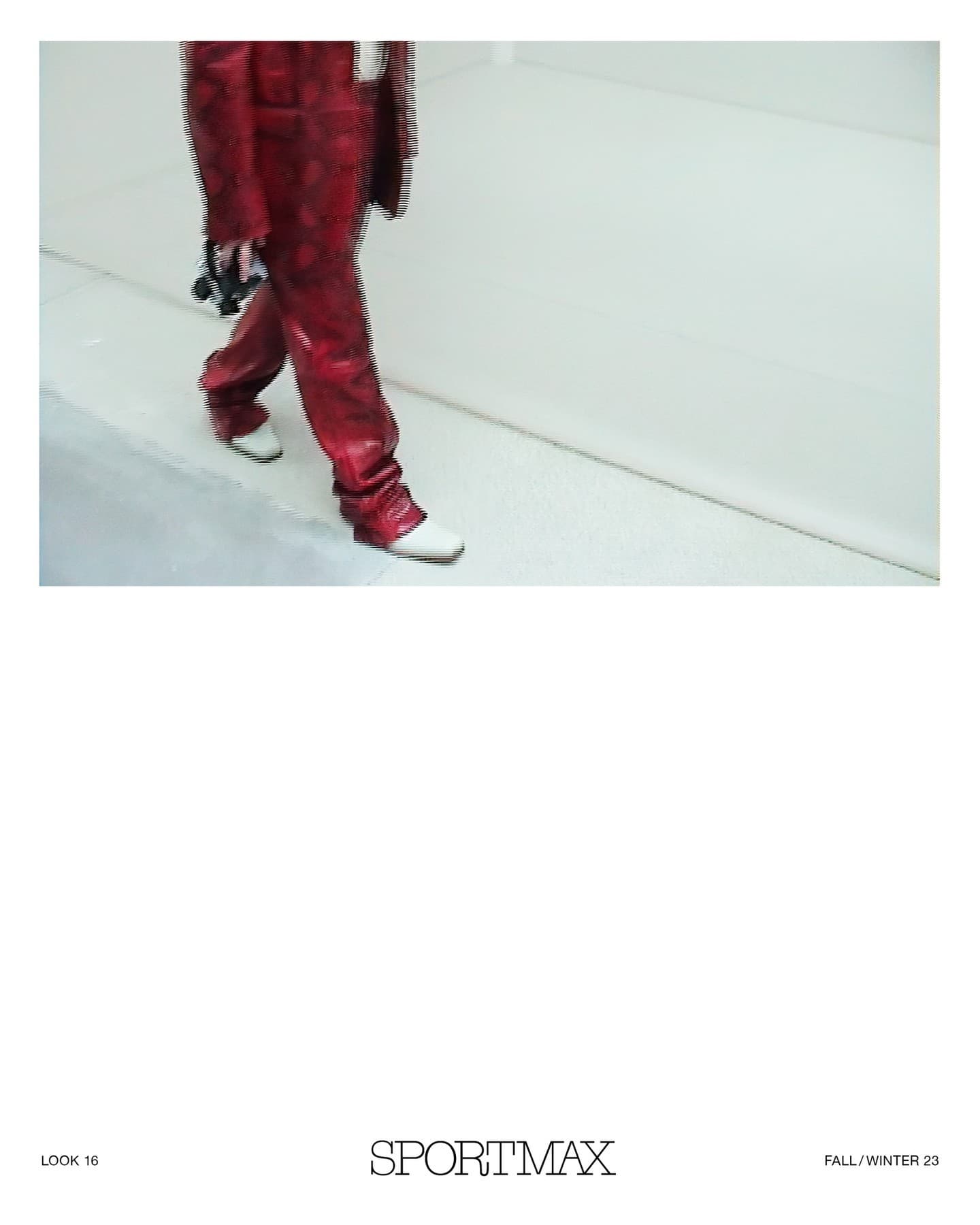 Fashion model wearing red leather pants and white shoes walking against a white wall for Sportmax fall/winter collection 2023.