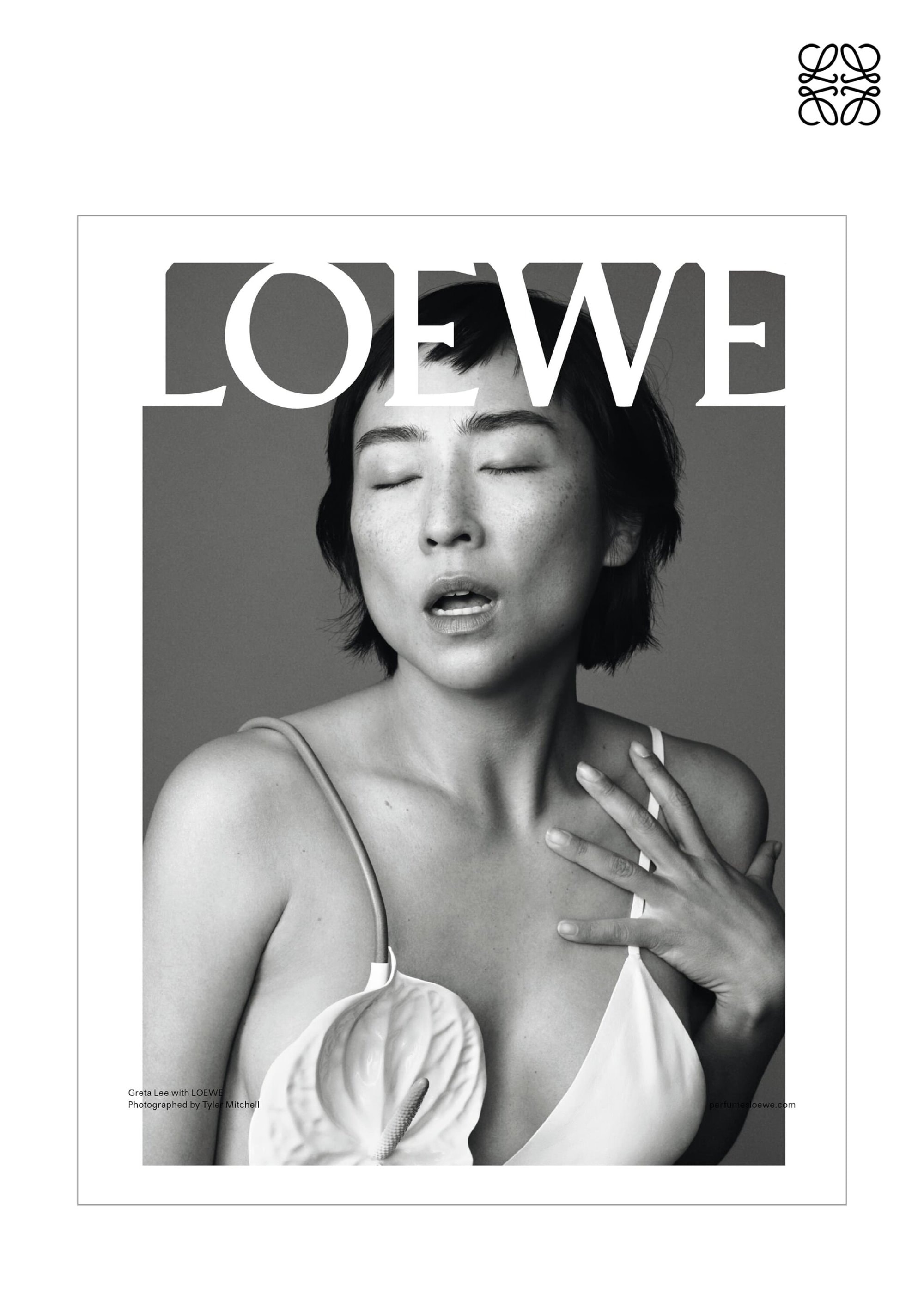 Black-and-white fashion shot featuring an Asian woman in a white top with a flower detail, eyes closed, and LOEWE logo.
