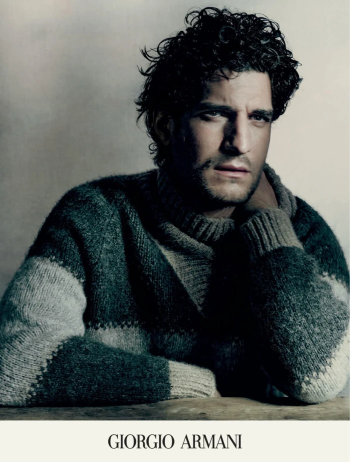 Louis Garrel wearing a textured turtleneck sweater in a campaign portrait for Giorgio Armani Fall 2023