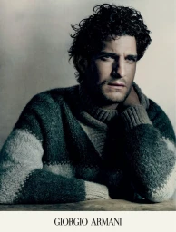 Louis Garrel wearing a textured turtleneck sweater in a campaign portrait for Giorgio Armani Fall 2023