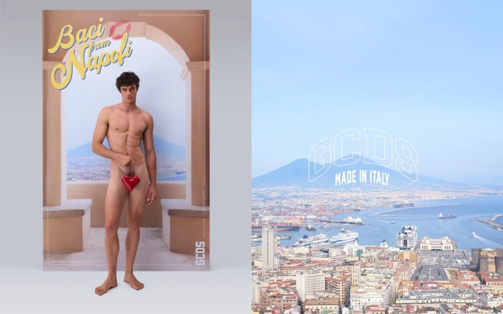 Shirtless man holds heart-shaped object in front of a backdrop featuring Naples cityscape and Mediterranean Sea; fashion-style.