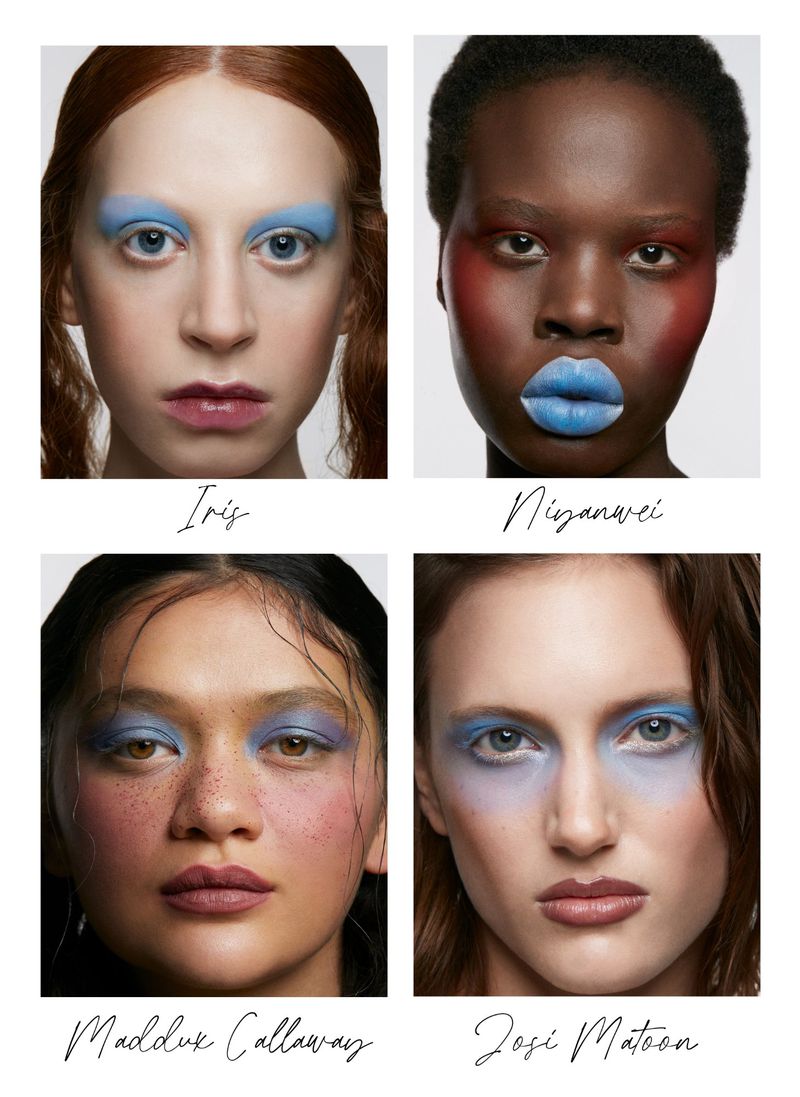 Four adult women display blue makeup on their eyebrows and lips in a beauty shot on a white background. Beauty & Fashion.
