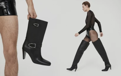 Model wearing black boots and mesh top walking against a seamless white background for Paul Andrew.