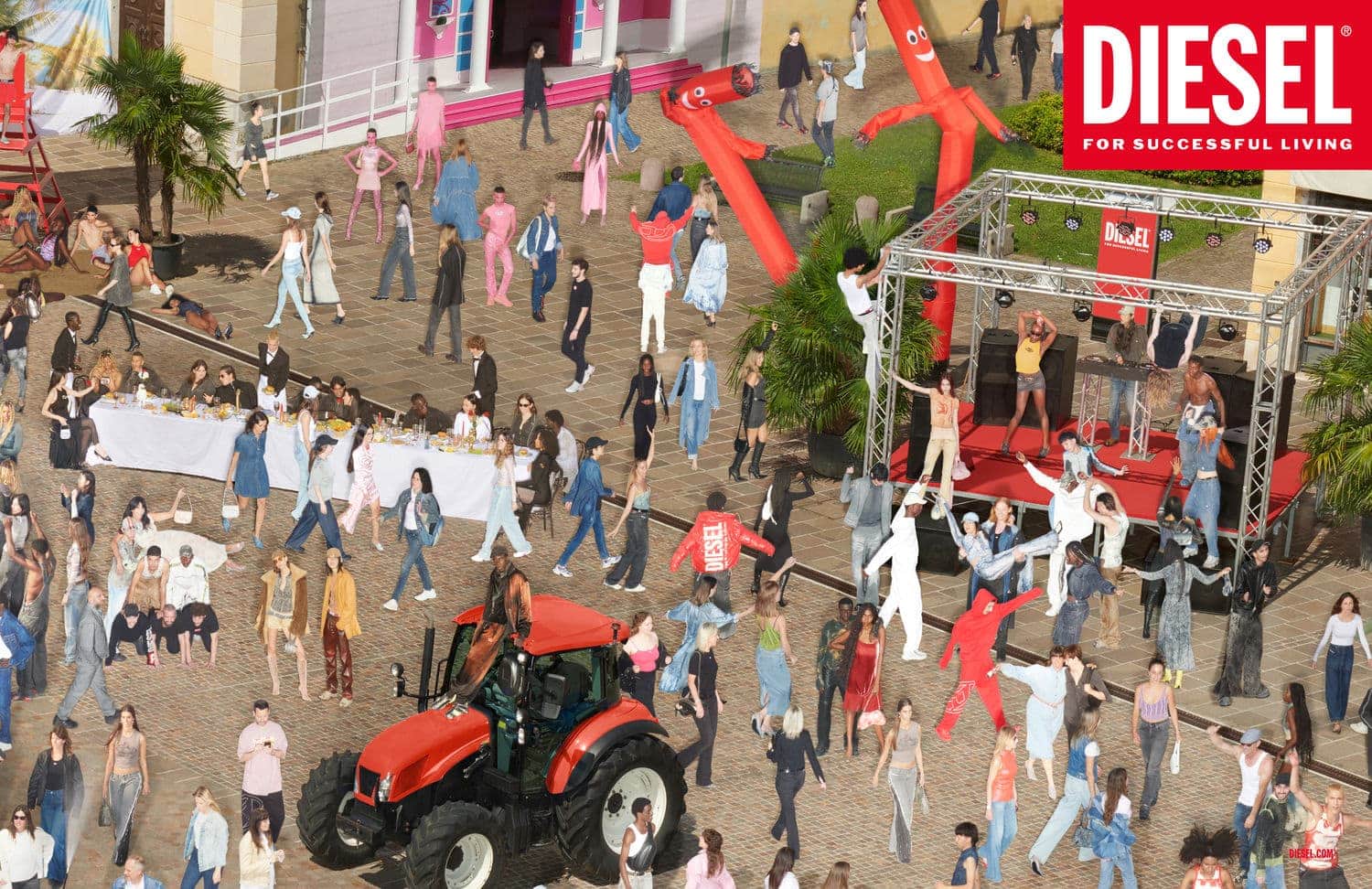 Outdoor fashion show featuring a large crowd, models on a stage, a red tractor, and inflatable tube men, set against a building backdrop.