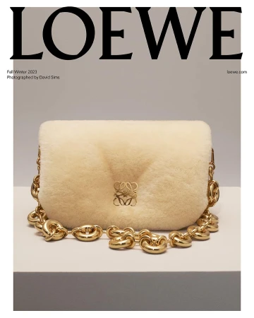 Loewe Fall/Winter 2023 campaign featuring a shearling bag with a chunky chain strap, presented on a white surface against a grey backdrop.