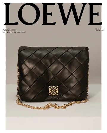 Loewe black nappa leather shoulder bag with chain strap and Anagram logo on a light grey background, studio photography.