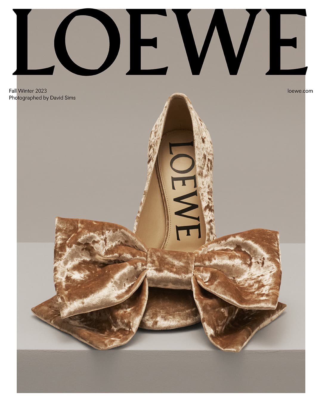 Loewe fall/winter 2023 campaign featuring a high-heeled shoe with a large bow. The neutral background accentuates the fashion-forward design.