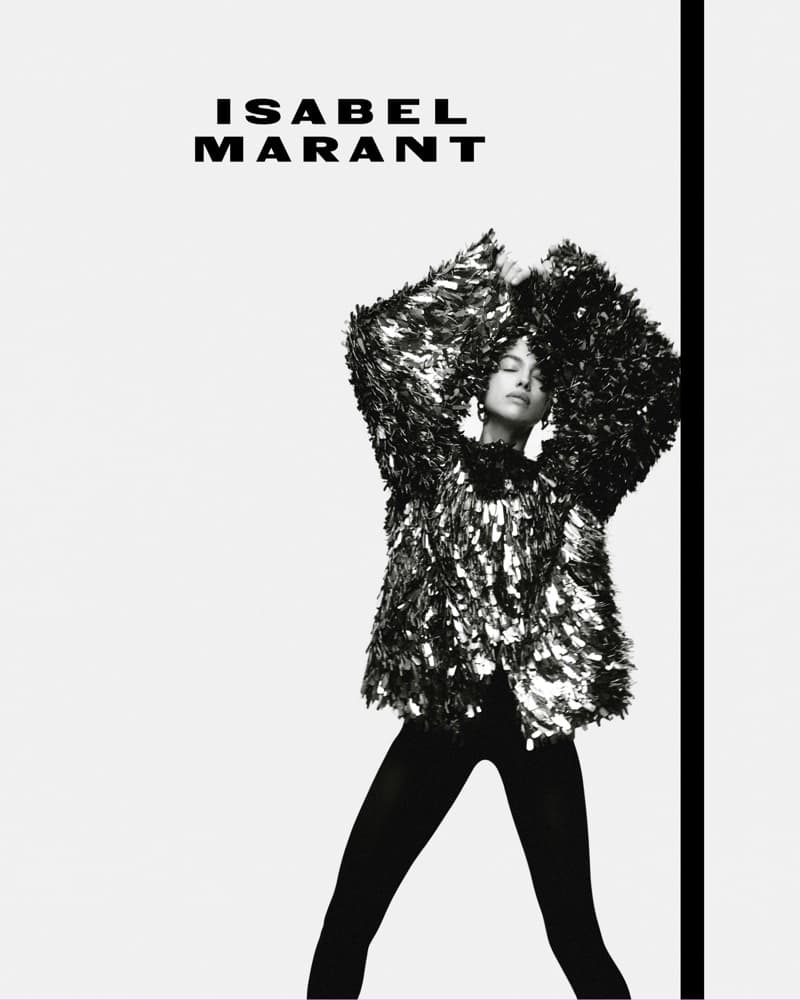 Monochrome fashion campaign image featuring Irina Shayk wearing a textured sparkly top and dark pants against a white background.