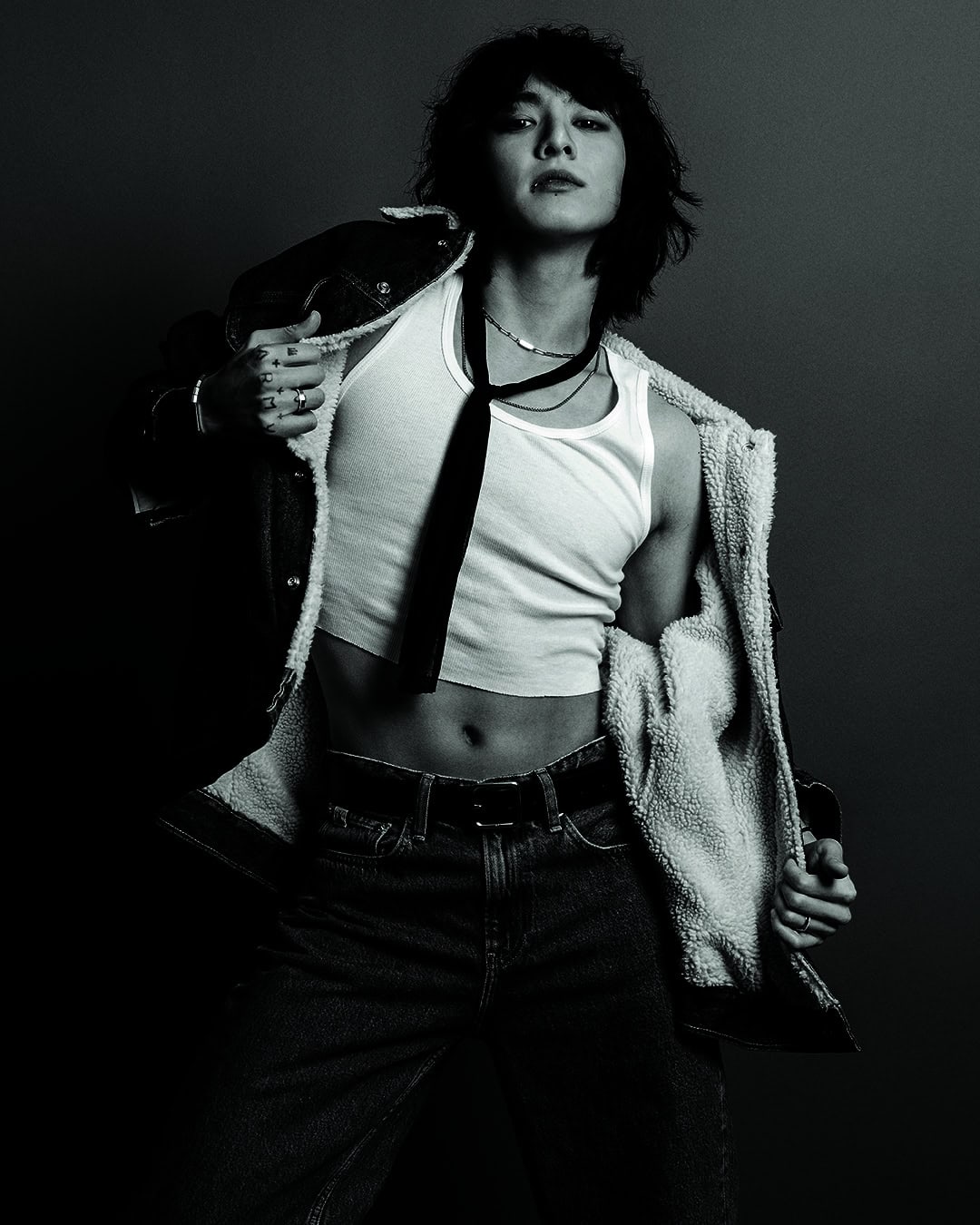 Jung Kook in a white tank top and denim jacket for Calvin Klein Fall 2023 ad campaign by Inez and Vinoodh.