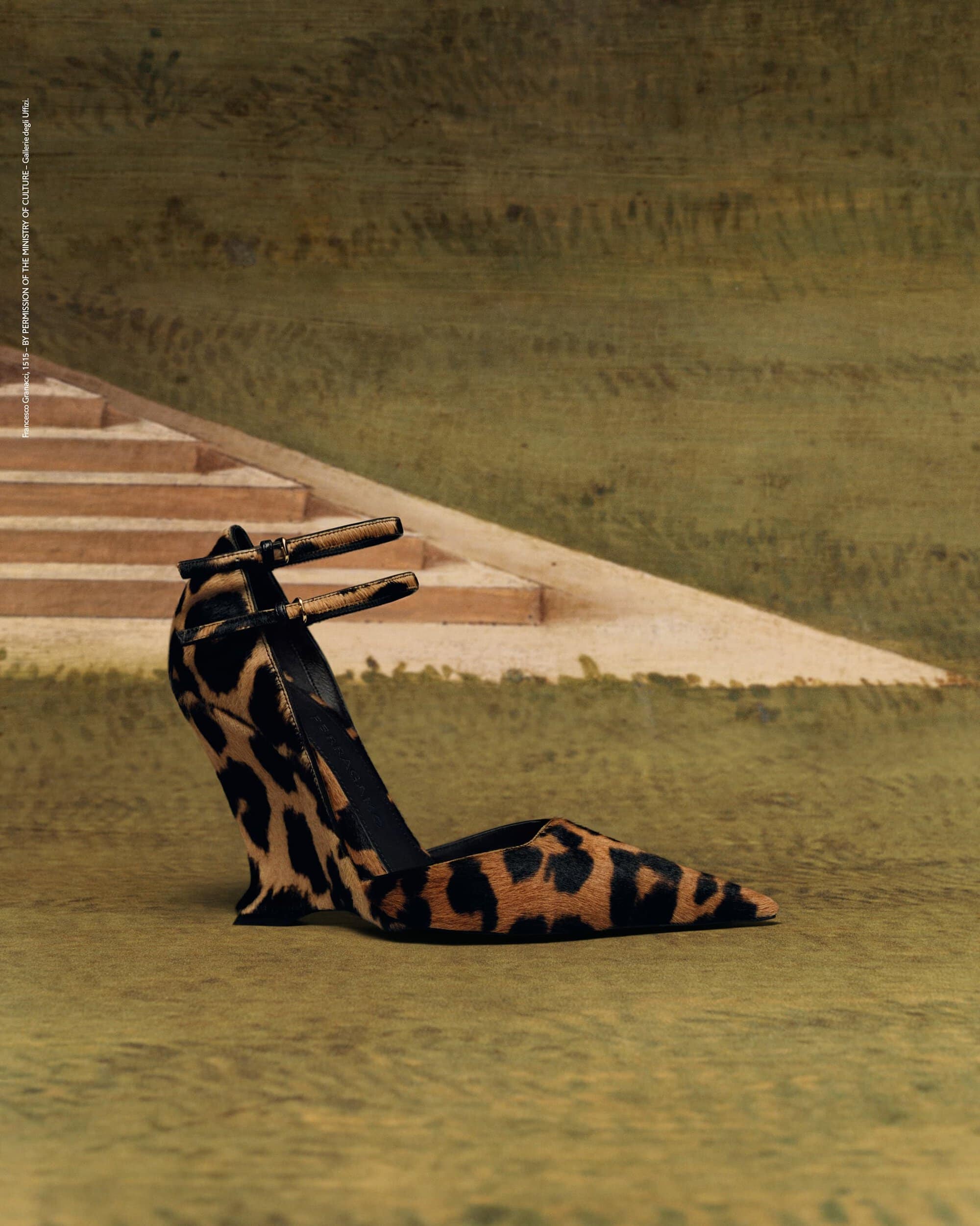 Stylish leopard-print heeled shoe displayed against a soft, muted green background with a suggestion of steps in the upper frame.