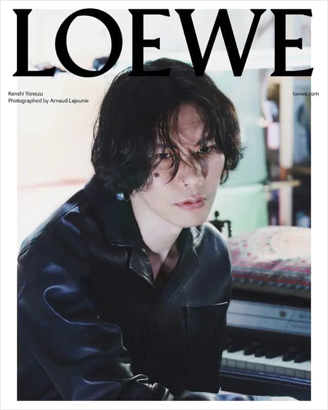 Kenshi Yonezu wearing a dark jacket in front of a piano for Loewe campaign photographed by Arnaud Lajeunie