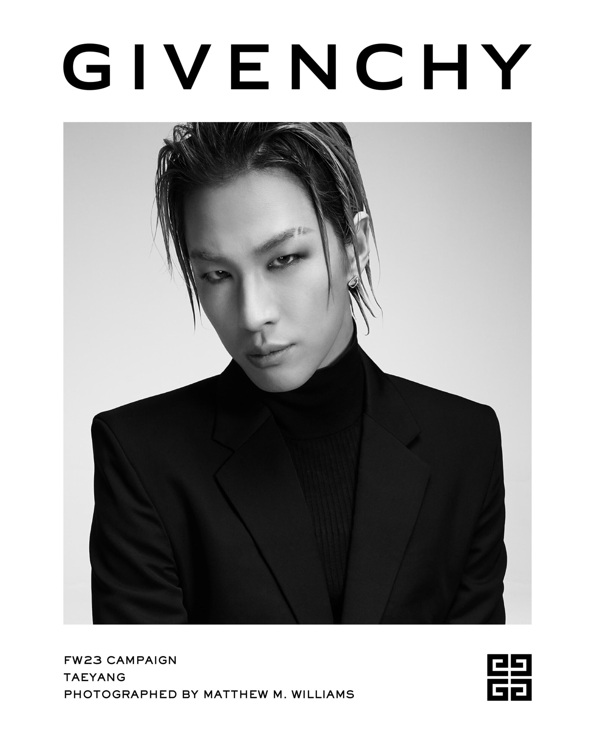 Givenchy campaign featuring Taeyang in black and white. Model in a dark suit and turtleneck against a bright backdrop.