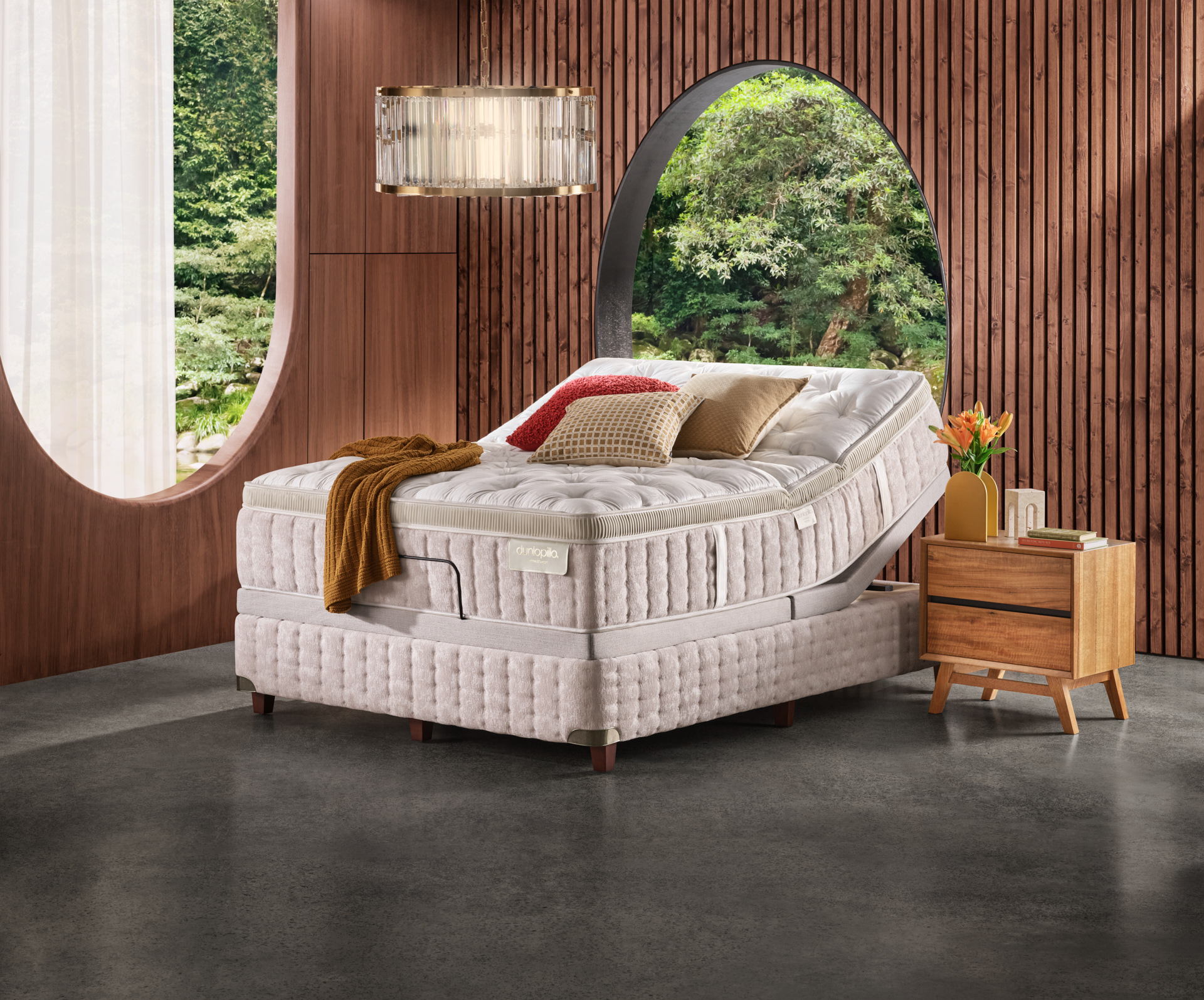 Contemporary bedroom setting featuring a luxurious mattress on an adjustable bed frame, complemented by modern bedside table and elegant decor.