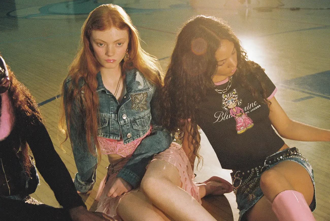 Three young fashion models showcase current trends in an indoor setting with colorful lighting and a vintage aesthetic.