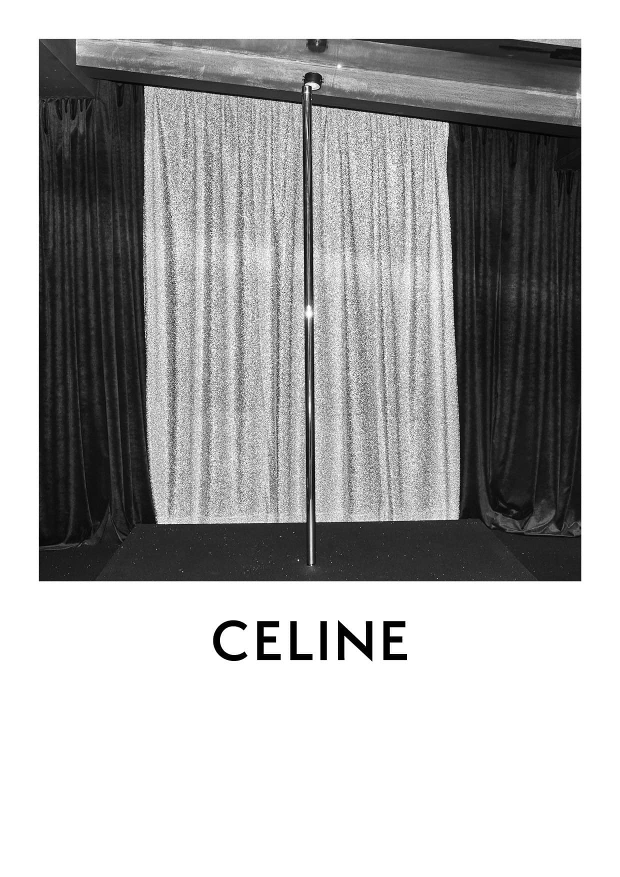 A black and white shot of a chrome dance pole standing center stage with dark and light curtains. The word CELINE is at the bottom.