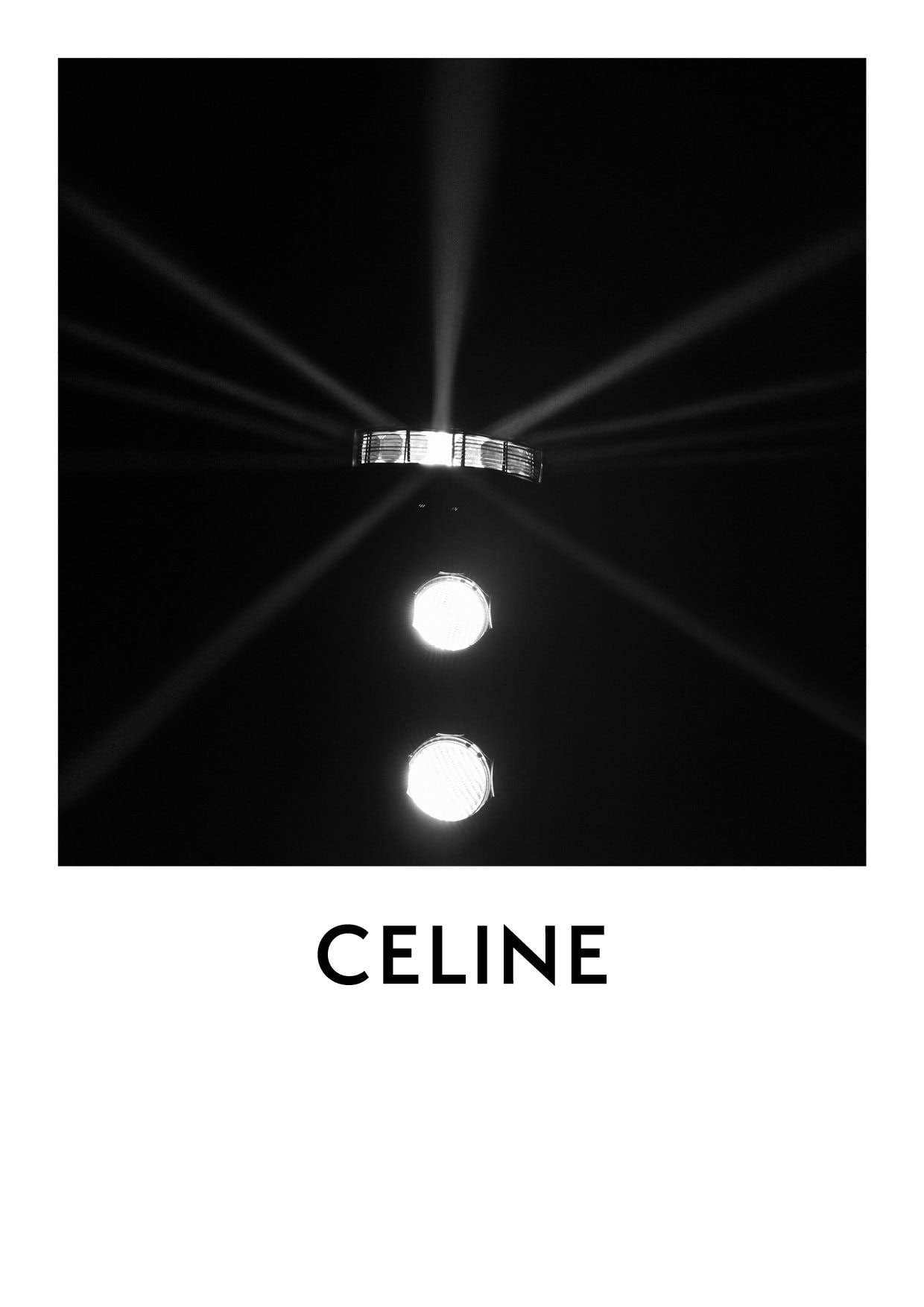 Abstract black and white image of stage lighting featuring spotlights and the CELINE logo against a dark, atmospheric background.