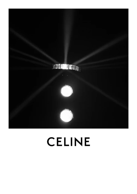 Abstract black and white image of stage lighting featuring spotlights and the CELINE logo against a dark, atmospheric background.