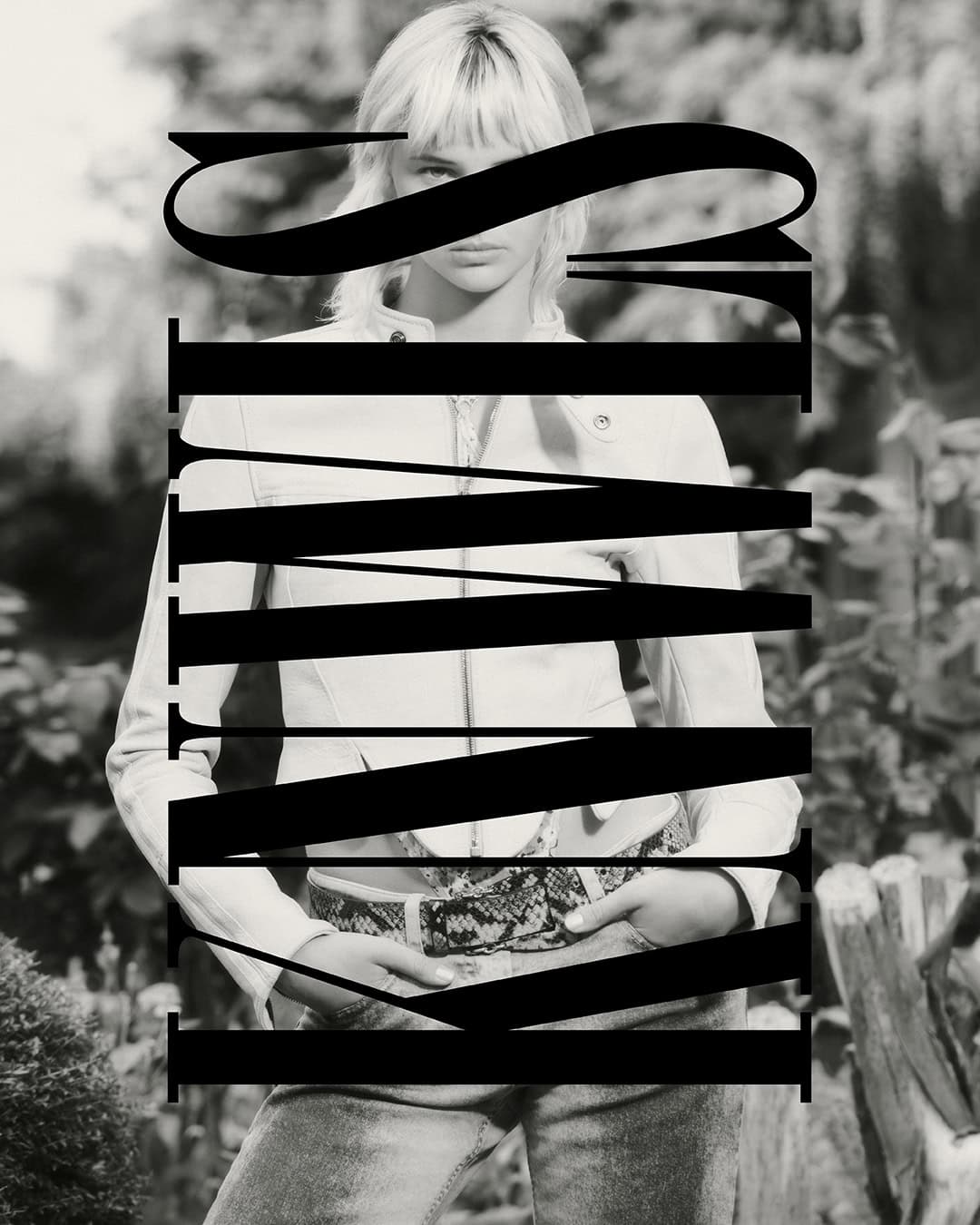 Monochrome portrait of a blonde woman wearing a light jacket and jeans outdoors, featuring prominent typography overlay.