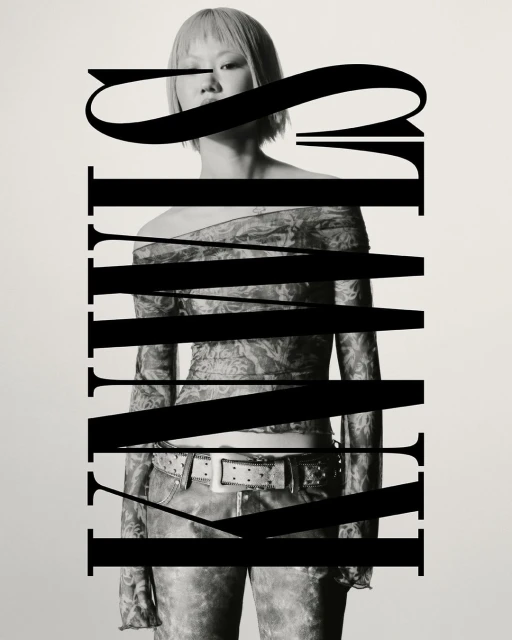 Monochrome portrait of a person with short hair wearing an off-the-shoulder top and jeans. Graphic text overlays the subject.