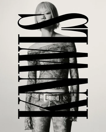Monochrome portrait of a person with short hair wearing an off-the-shoulder top and jeans. Graphic text overlays the subject.