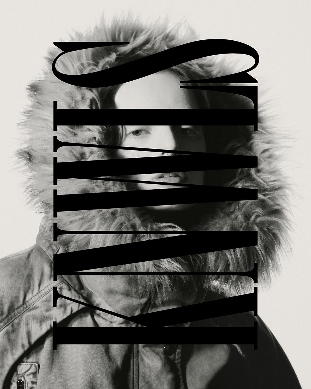 Monochrome portrait of a person wearing a hooded winter coat, with large black text overlaying the center of the image.