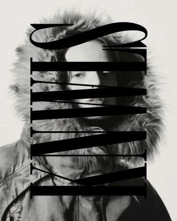 Monochrome portrait of a person wearing a hooded winter coat, with large black text overlaying the center of the image.