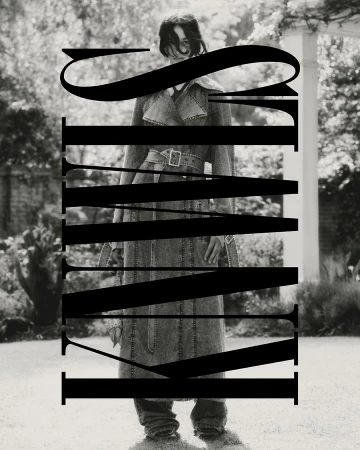 Monochrome portrait of a woman in a denim trench coat posing outdoors with bold typography overlaying the image, editorial fashion.