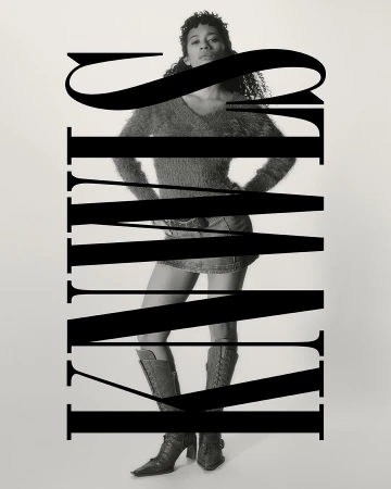 Black and white fashion photograph of a woman in a mini skirt and boots, posed against a light background and obscured by bold typography.