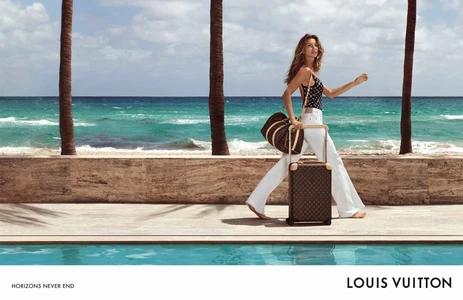 Gisele Bündchen walking poolside with Louis Vuitton monogram luggage against an ocean backdrop.