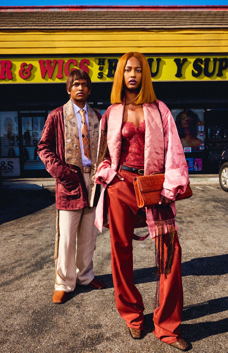 Two models posing outside a storefront with a yellow sign for Free As My Hair for V Magazine photographed by Danielle Levitt.