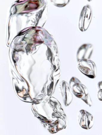 Macro shot of clear, iridescent water bubbles against a bright white background with smooth surfaces and organic liquid forms.