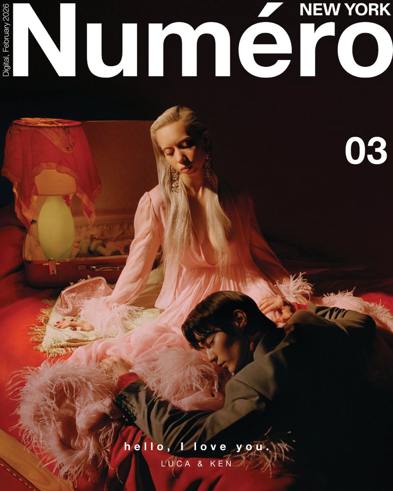 Numero New York cover featuring a blonde woman in a pink dress and a man in a grey suit on a red bed, accented by pink feathers.