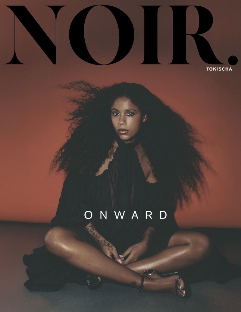 Portrait of Tokischa wearing a black dress and sitting cross-legged against a rusty orange background. 'NOIR' and 'ONWARD' text overlay.