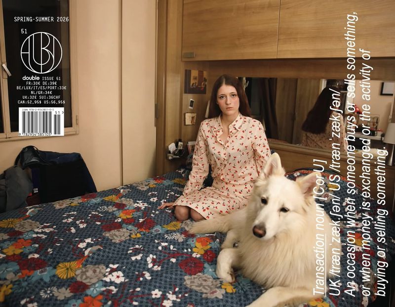 Magazine cover featuring a woman in pajamas and a white dog on a floral patterned bed in a bedroom setting with text overlays.