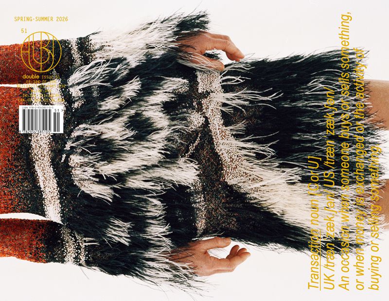 Fashion magazine cover featuring a model wearing a fringed garment with text overlay and Spring-Summer 2026 title, on a clean background.