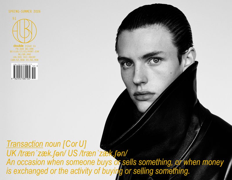 Fashion magazine cover featuring a young male model with slicked-back hair wearing a black leather jacket against a light background.