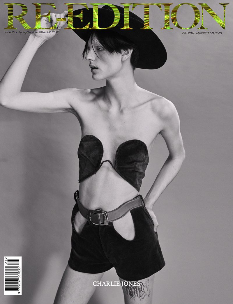 Fashion magazine cover featuring a model in black vintage-style clothing and a wide-brimmed hat against a gray backdrop.