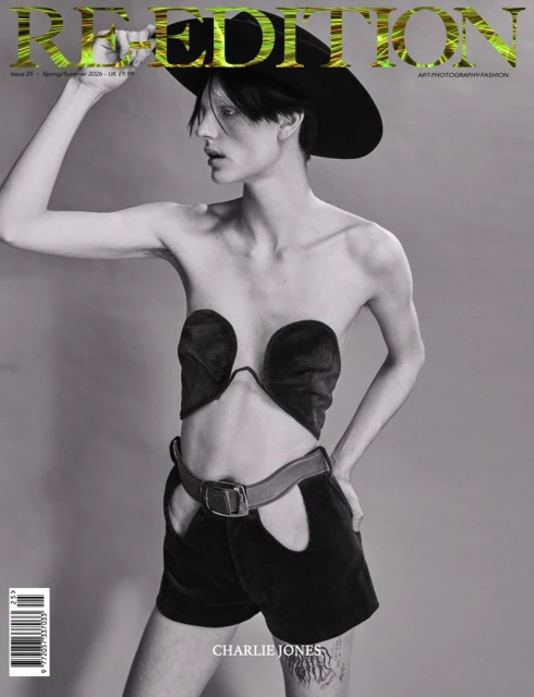 Fashion magazine cover featuring a model in black vintage-style clothing and a wide-brimmed hat against a gray backdrop.