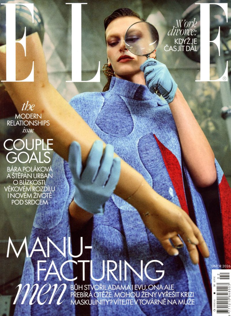 Magazine cover featuring a female model wearing a blue dress and gloves, holding a magnifying glass and a prosthetic arm.
