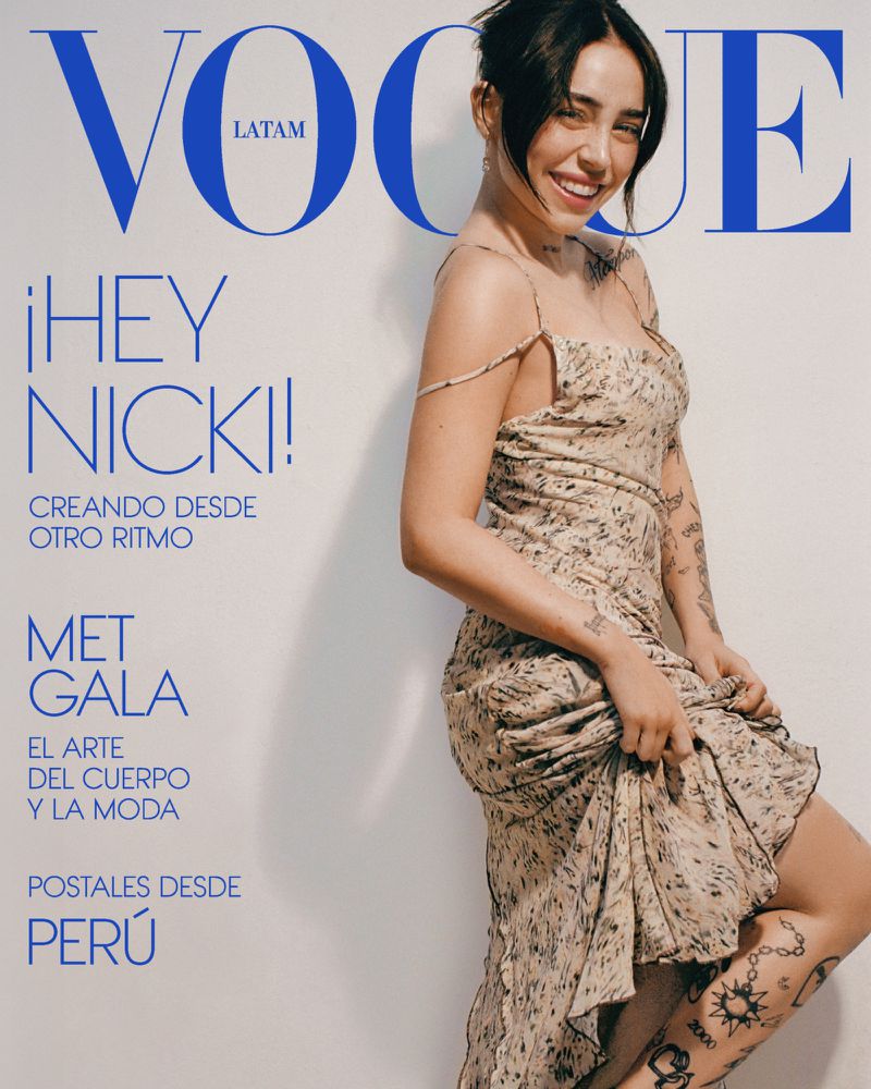 Vogue Latin America cover featuring a smiling woman in a floral dress, posing in front of a white background with the magazine's logo.