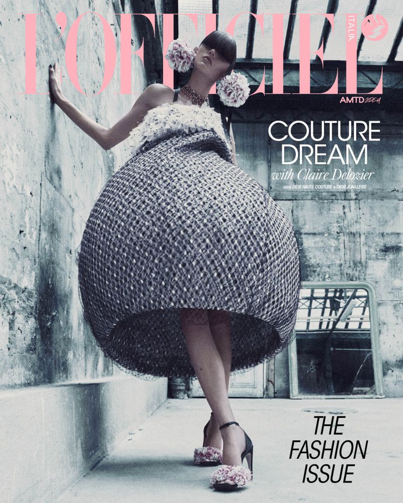 Magazine cover featuring a model in a large spherical dress, leaning against a wall with floral details and dramatic lighting.