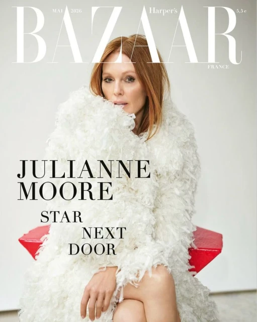 Julianne Moore wearing a textured white feathered coat seated on a red stool for Harper's Bazaar France magazine cover.