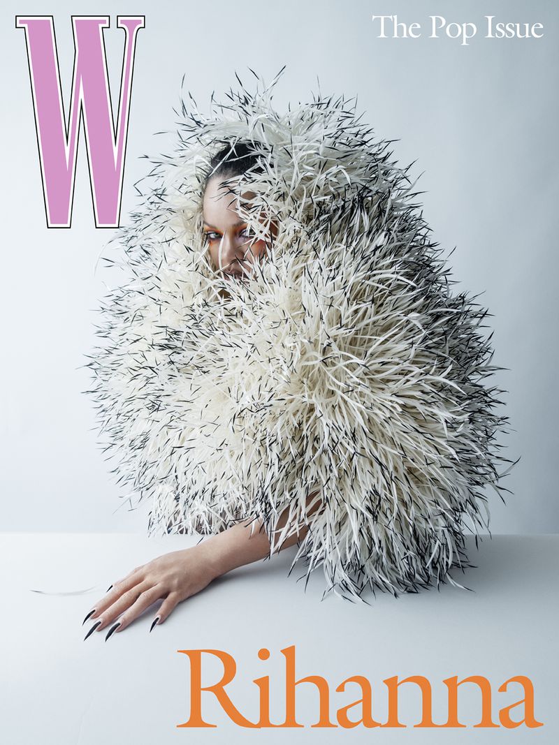 Magazine cover featuring Rihanna in a feathered garment, captured in a studio setting with bold typography and clean composition.