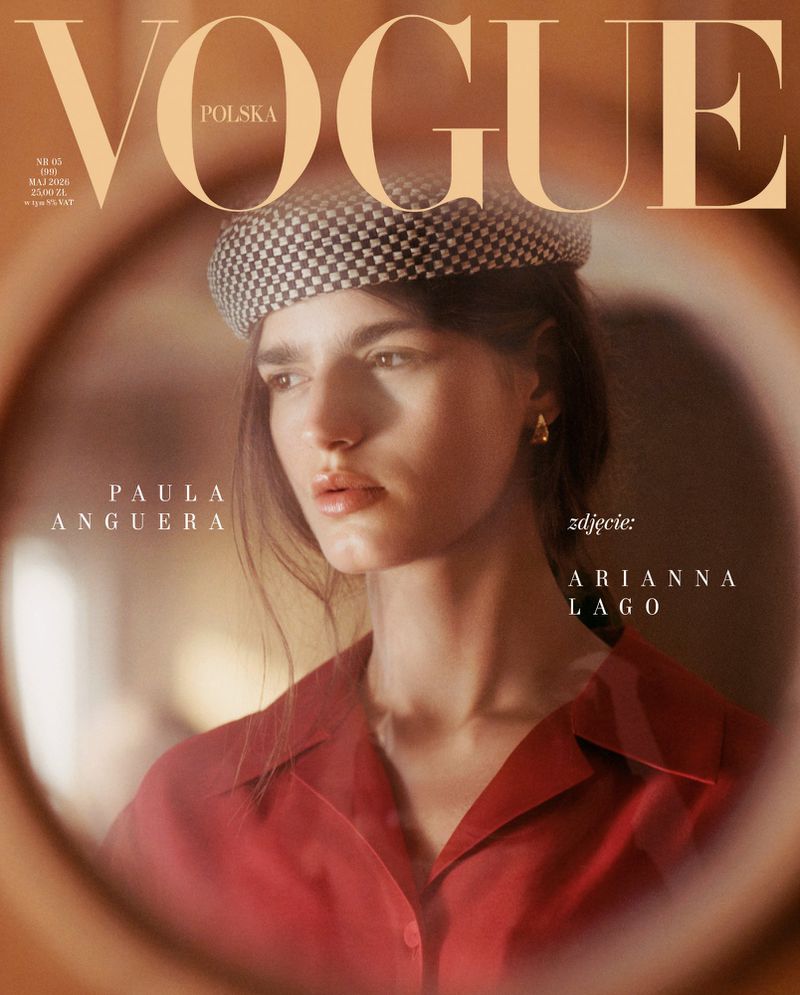 Vogue Polska cover featuring a woman with medium-length brown hair, wearing a checkered hat and red blouse, as seen through a blurry round frame.