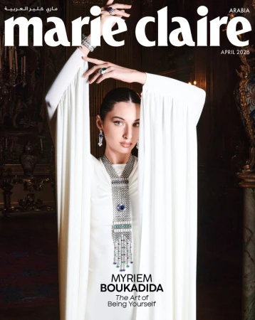 Marie Claire Arabia cover featuring Myriem Boukadida in a white dress and jewelry. Dark interior background. Magazine cover.