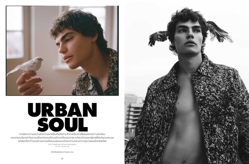 Editorial fashion shot of a young man in patterned jacket with bird on hand indoors and with wings and jacket outdoors.