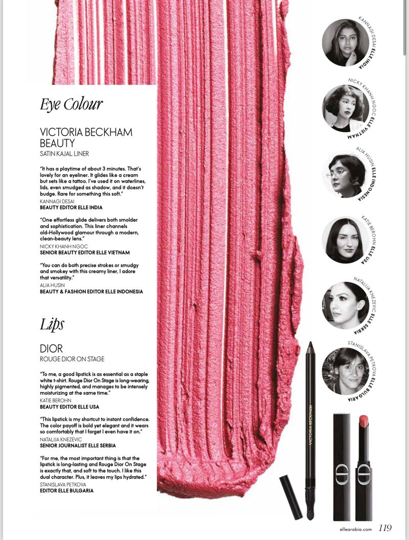 Close-up of a pink lipstick swatch next to makeup and cosmetic products from Dior and Victoria Beckham Beauty in studio lighting.