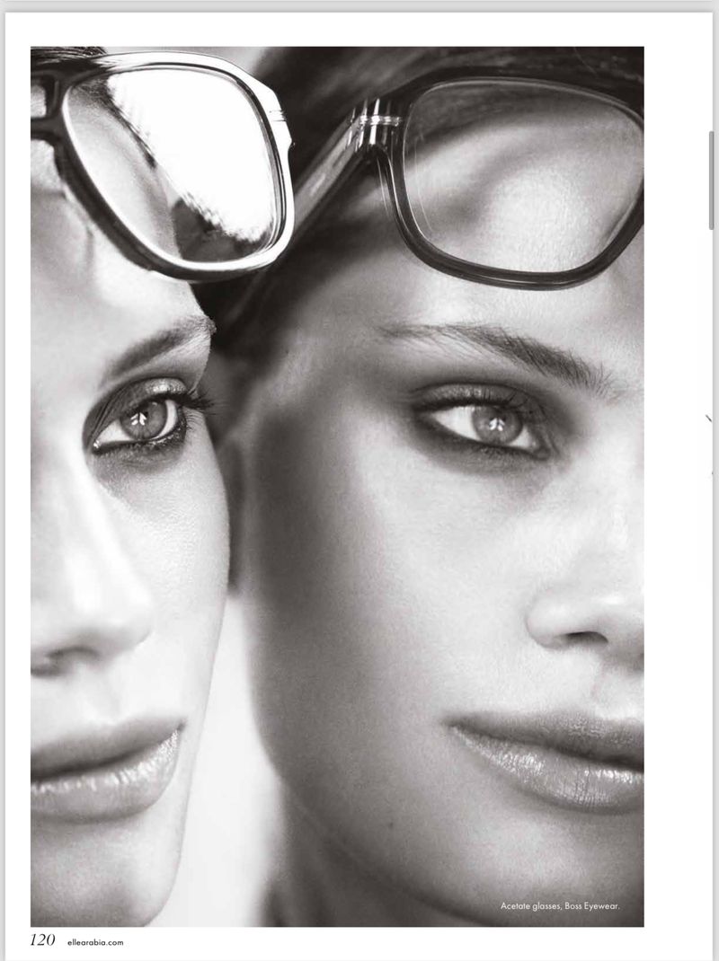 Monochrome shot of two women's faces, close-up, wearing glasses. Fashion eyewear advertisement with beauty focus on eyes and lips.